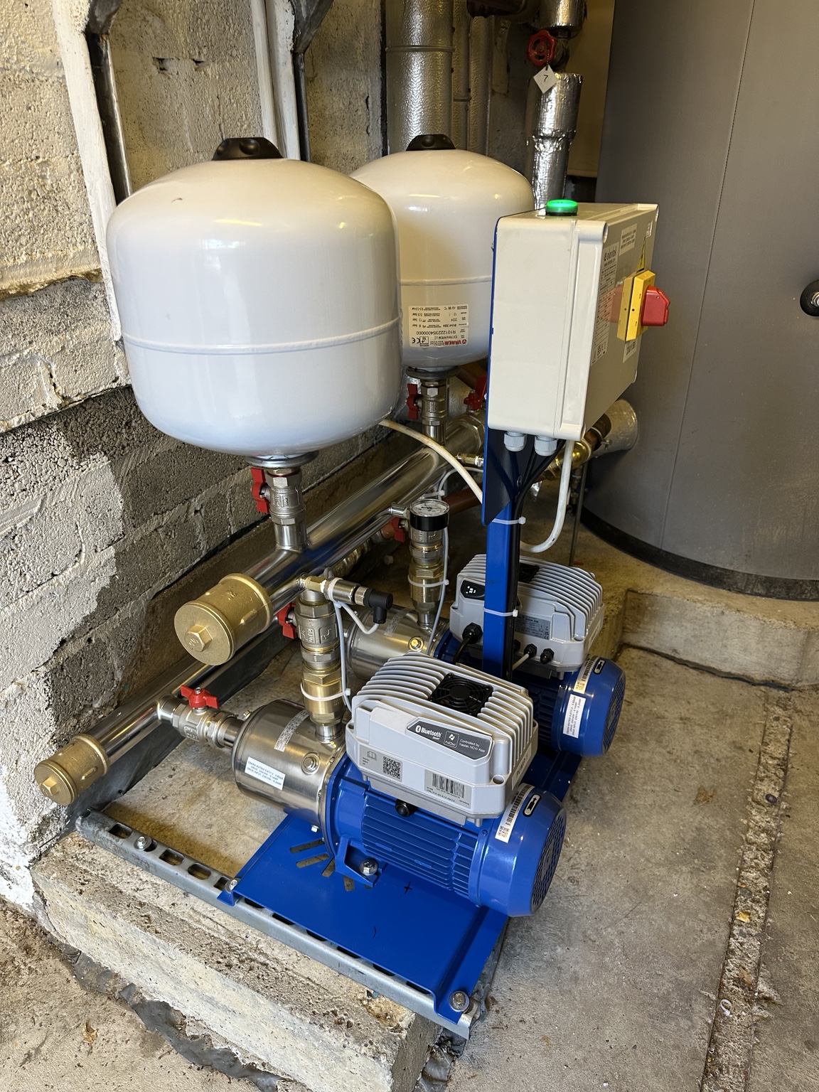Real HydroPro installation photograph showing a completed twin booster pump set with vessels and associated controls